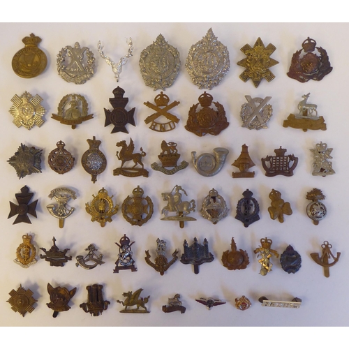 272 - Approximately fifty military metal cap badges, some copies: to include 'The Norfolk Regiment'(Please... 