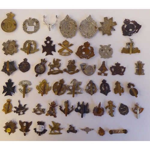 272 - Approximately fifty military metal cap badges, some copies: to include 'The Norfolk Regiment'(Please... 