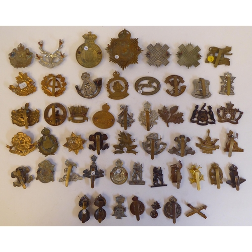 275 - Approximately fifty military metal cap badges, some copies: to include 'Cardiff Regiment'(Please Not... 