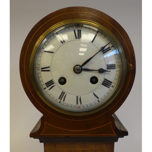 279 - An Edwardian string inlaid mantel clock of tower form, on a plinth and bun feet; the movement faced ... 