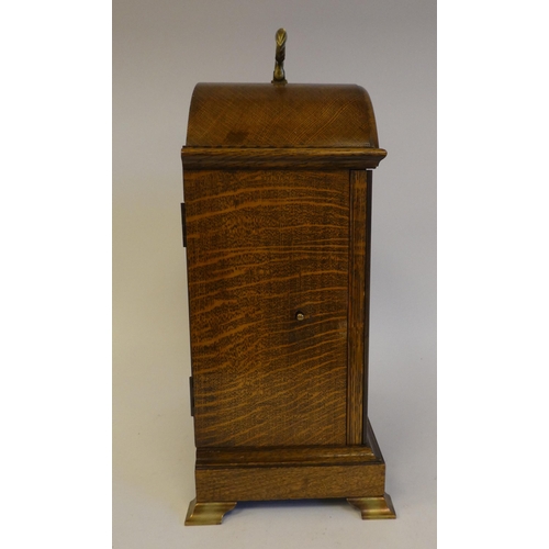 280 - A 20thC Elliot oak cased mantel clock, on a plinth and brass feet; the chiming movement faced by a b... 