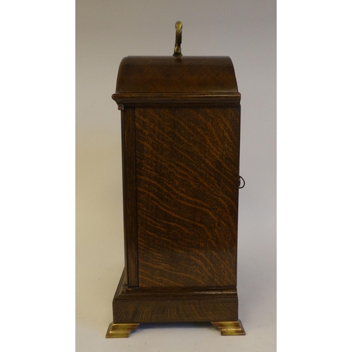 280 - A 20thC Elliot oak cased mantel clock, on a plinth and brass feet; the chiming movement faced by a b... 