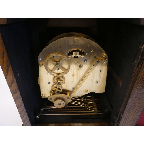 280 - A 20thC Elliot oak cased mantel clock, on a plinth and brass feet; the chiming movement faced by a b... 