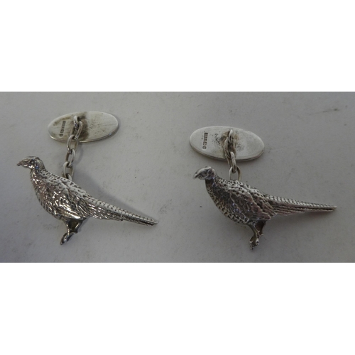 285 - A pair of silver cufflinks, in the form of a pheasant with an oval tablet, on chain  Birmingham 1994... 