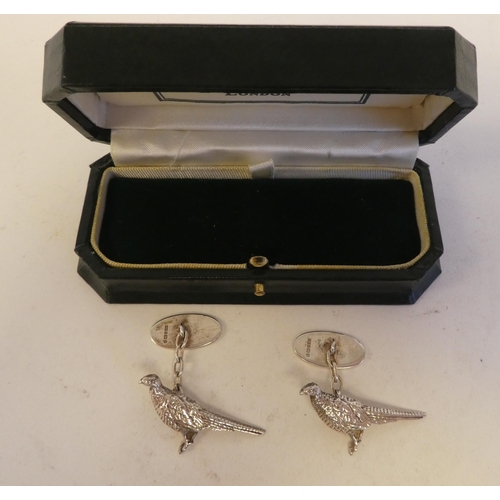 285 - A pair of silver cufflinks, in the form of a pheasant with an oval tablet, on chain  Birmingham 1994... 