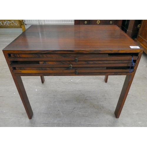 294 - A mid 20thC Scandinavian Illum Wikkelso rosewood side table, housing three folding tables, raised on... 