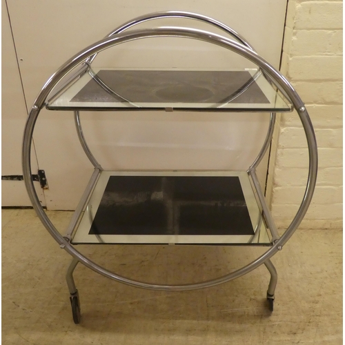 60 - A reproduction of an Art Deco inspired, chromium plated, framed and glazed, two tier hostess trolley... 