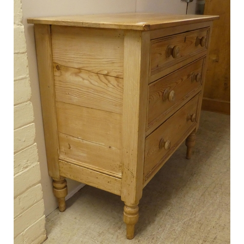 90 - An early 20thC pine, three drawer dressing chest, raised on turned legs  32