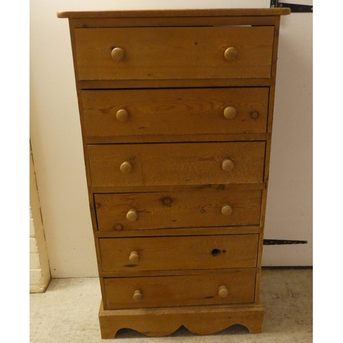 93 - An early/mid 20thC pine, six drawer tall boy, raised on a bracket plinth  42