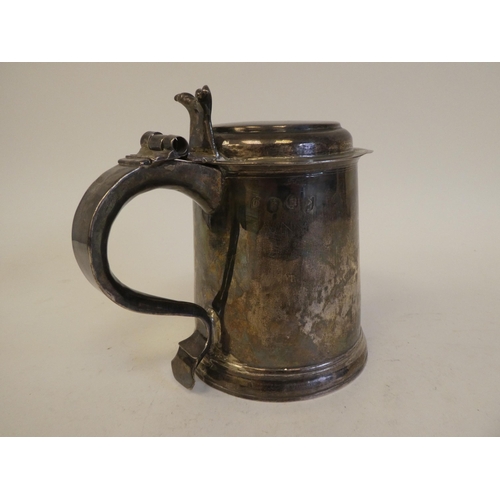 318 - A Queen Anne silver tankard with a hinged lid and an ear shaped handle  London 1706  15.7ozs  5.5