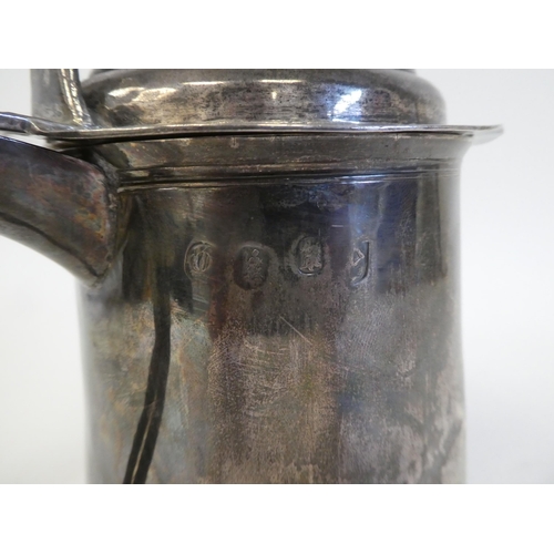 318 - A Queen Anne silver tankard with a hinged lid and an ear shaped handle  London 1706  15.7ozs  5.5