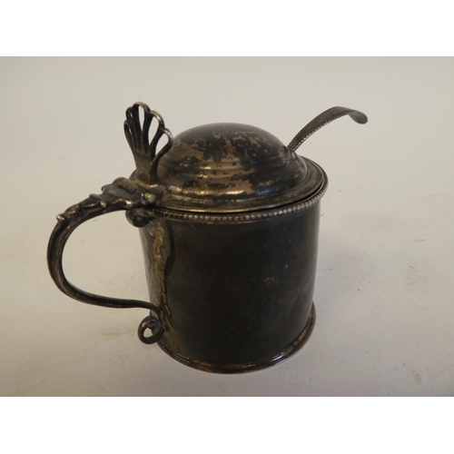 319 - A George III silver mustard pot of cylindrical form with a hinged lid and a blue glass liner  L... 