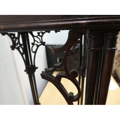 102 - An Edwardian Chippendale inspired mahogany kettle stand with a pierced gallery, raised on triple clu... 