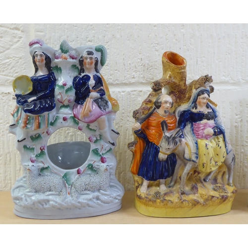 112 - Victorian Staffordshire pottery flatback figures: to include a man and woman, in Scottish dress ... 