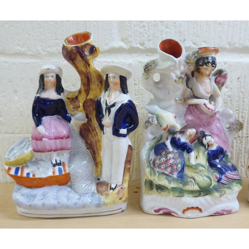 112 - Victorian Staffordshire pottery flatback figures: to include a man and woman, in Scottish dress ... 