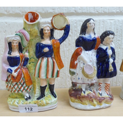 112 - Victorian Staffordshire pottery flatback figures: to include a man and woman, in Scottish dress ... 