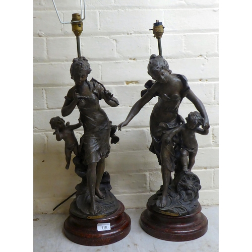 118 - A pair of late 19thC spelter figural lamps, each fashioned as a woman with a cherubic figure  25