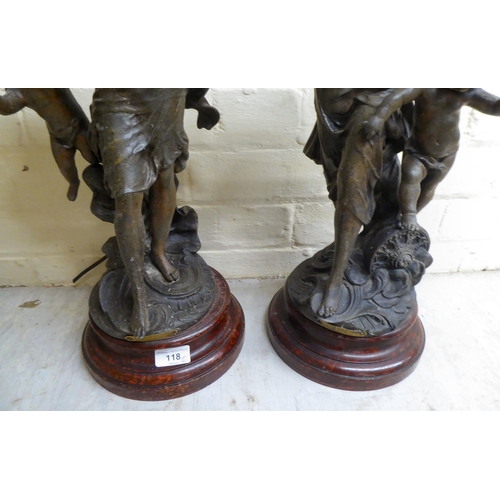 118 - A pair of late 19thC spelter figural lamps, each fashioned as a woman with a cherubic figure  25