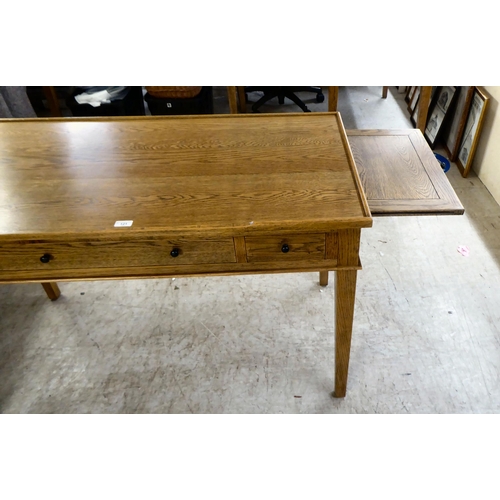 121 - A modern OKA oak desk with three drawers, raised on square, tapered legs  31