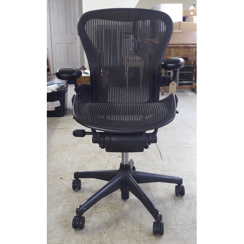 122 - A Herman Miller Aeron design, swivel office chair, raised on casters