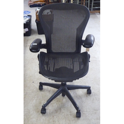 122 - A Herman Miller Aeron design, swivel office chair, raised on casters