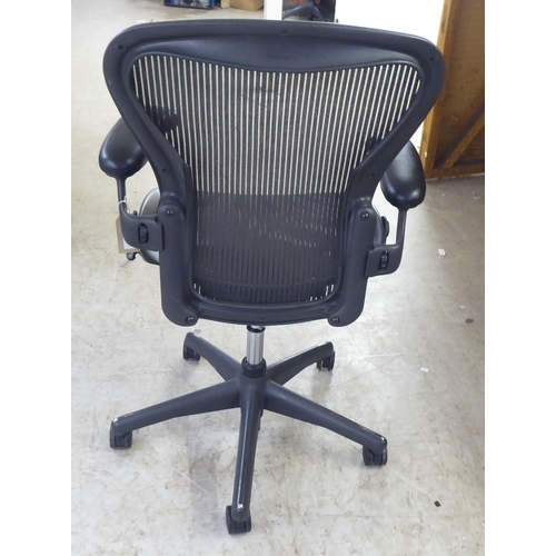 122 - A Herman Miller Aeron design, swivel office chair, raised on casters