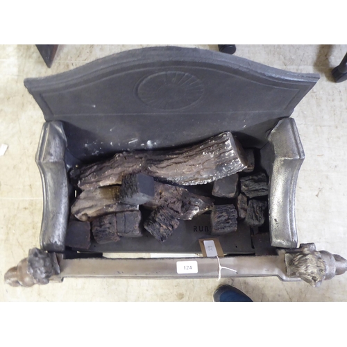 124 - A cast iron and steel fireplace with lion mask finials, raised on paw feet  28