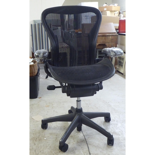 126 - A Herman Miller Aeron design, swivel office chair, raised on casters