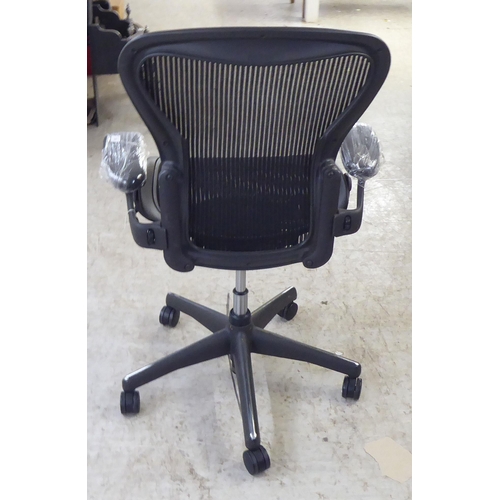 126 - A Herman Miller Aeron design, swivel office chair, raised on casters