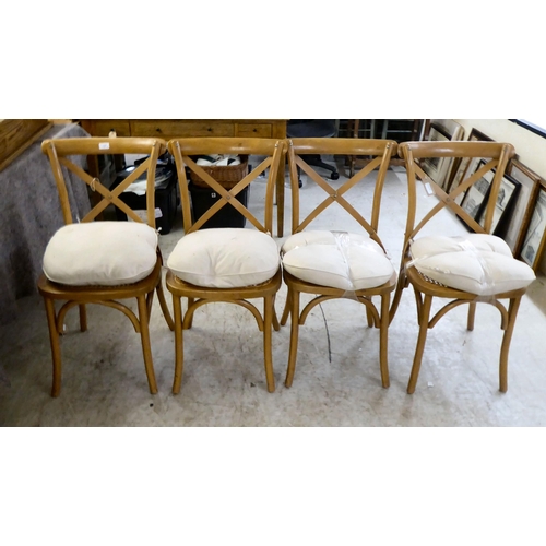 127 - A set of four stained beech kitchen chairs, each with a caned seat, raised on splayed legs 