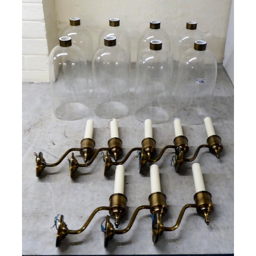 128 - A set of eight brass finished wall lights, each with a clear glass cylindrical shade  19