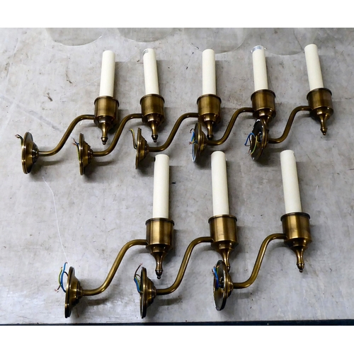 128 - A set of eight brass finished wall lights, each with a clear glass cylindrical shade  19