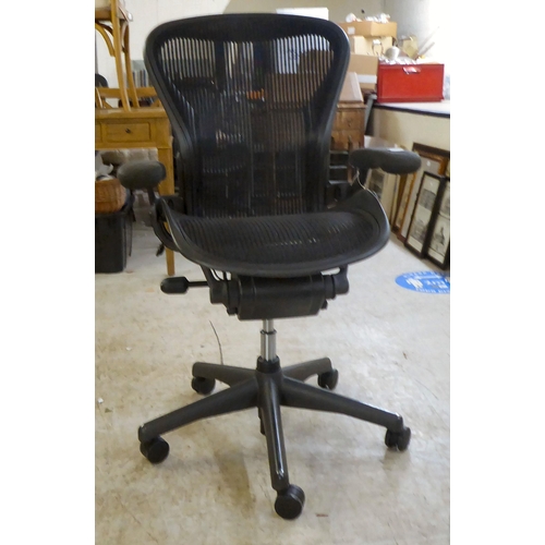 129 - A Herman Miller Aeron design, swivel office chair, raised on casters