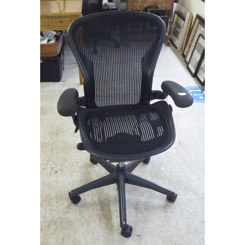 129 - A Herman Miller Aeron design, swivel office chair, raised on casters