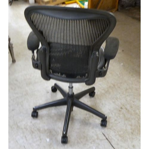 129 - A Herman Miller Aeron design, swivel office chair, raised on casters