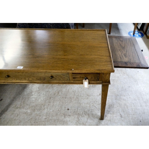 130 - A modern OKA oak desk with three drawers, raised on square, tapered legs  31