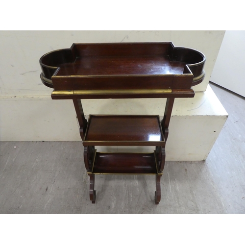 133 - An Edwardian mahogany three tier book stand, raised on arched legs  29