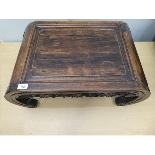 136 - An early 20thC Chinese rosewood ceremonial table with a leaf and berry carved frieze, raised on curv... 