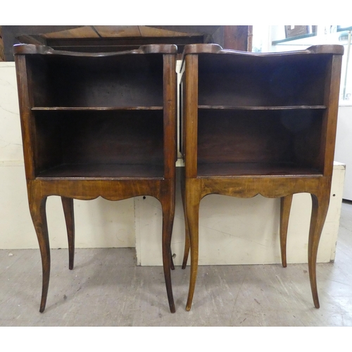 141 - A pair of late 19thC Continental stained beech bedside tables, each with two shelves, raised on cabr... 