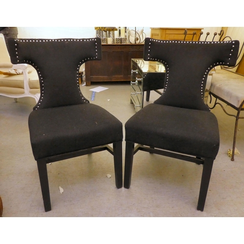 153 - A pair of modern curved back chairs, upholstered in black fabric, decorated with studs