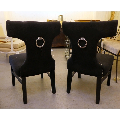 153 - A pair of modern curved back chairs, upholstered in black fabric, decorated with studs