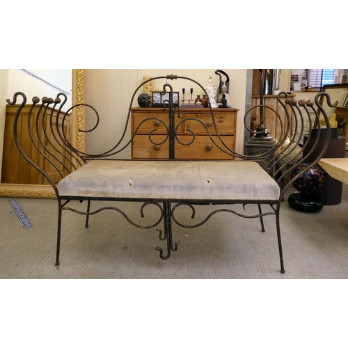 163 - A modern metal framed bench of whiplash design with a cushioned seat  44