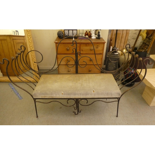 163 - A modern metal framed bench of whiplash design with a cushioned seat  44