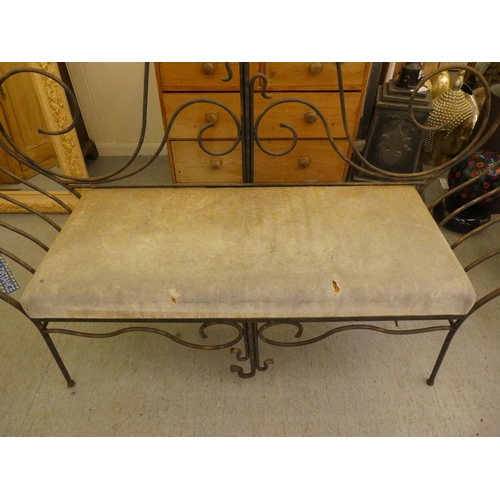 163 - A modern metal framed bench of whiplash design with a cushioned seat  44