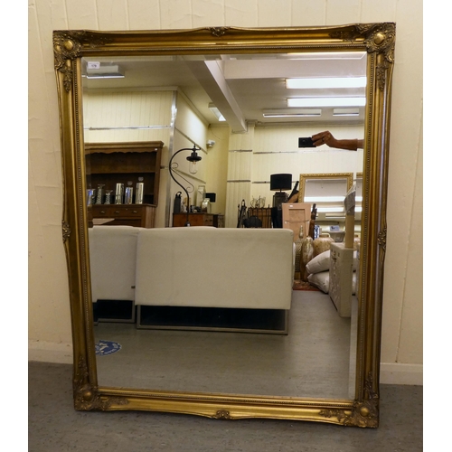 179 - A modern mirror, the bevelled plate set in a gilt frame  51