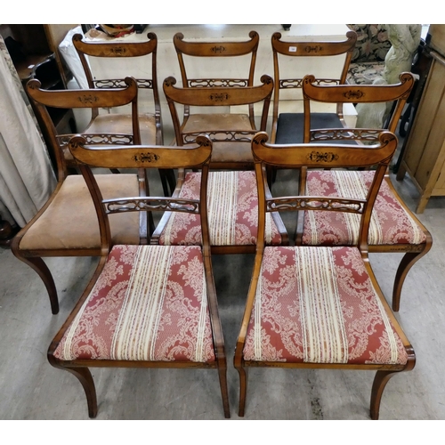 189 - A set of eight Early 19th Century faux satinwood dining chairs, each with a double scrolled crest an... 