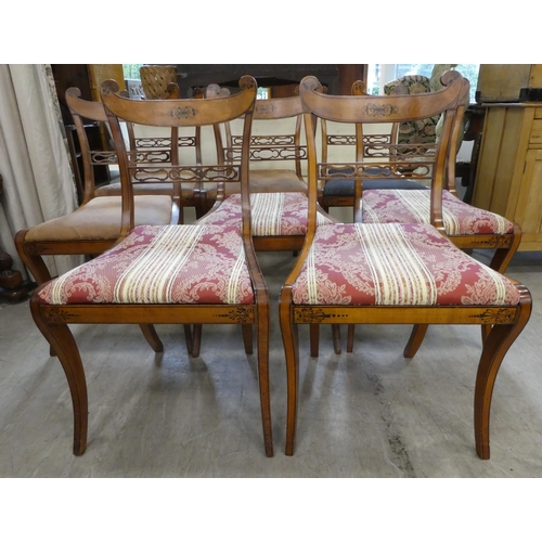 189 - A set of eight Early 19th Century faux satinwood dining chairs, each with a double scrolled crest an... 