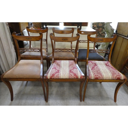 189 - A set of eight Early 19th Century faux satinwood dining chairs, each with a double scrolled crest an... 