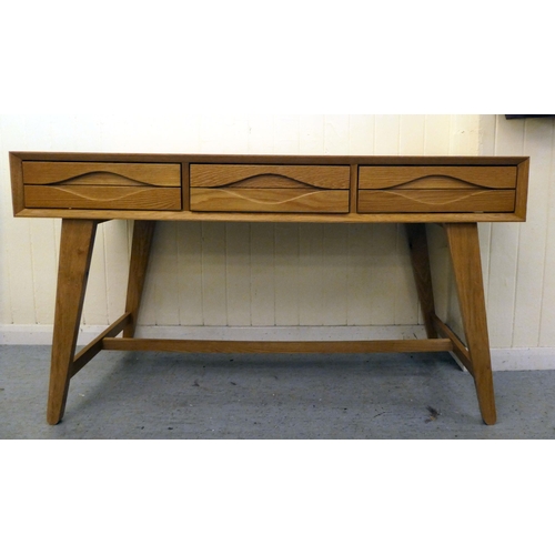 217 - A modern light oak, three drawer side table, raised on tapered legs  32