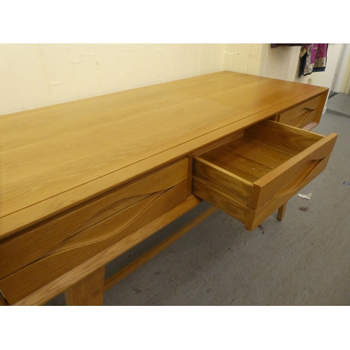 217 - A modern light oak, three drawer side table, raised on tapered legs  32